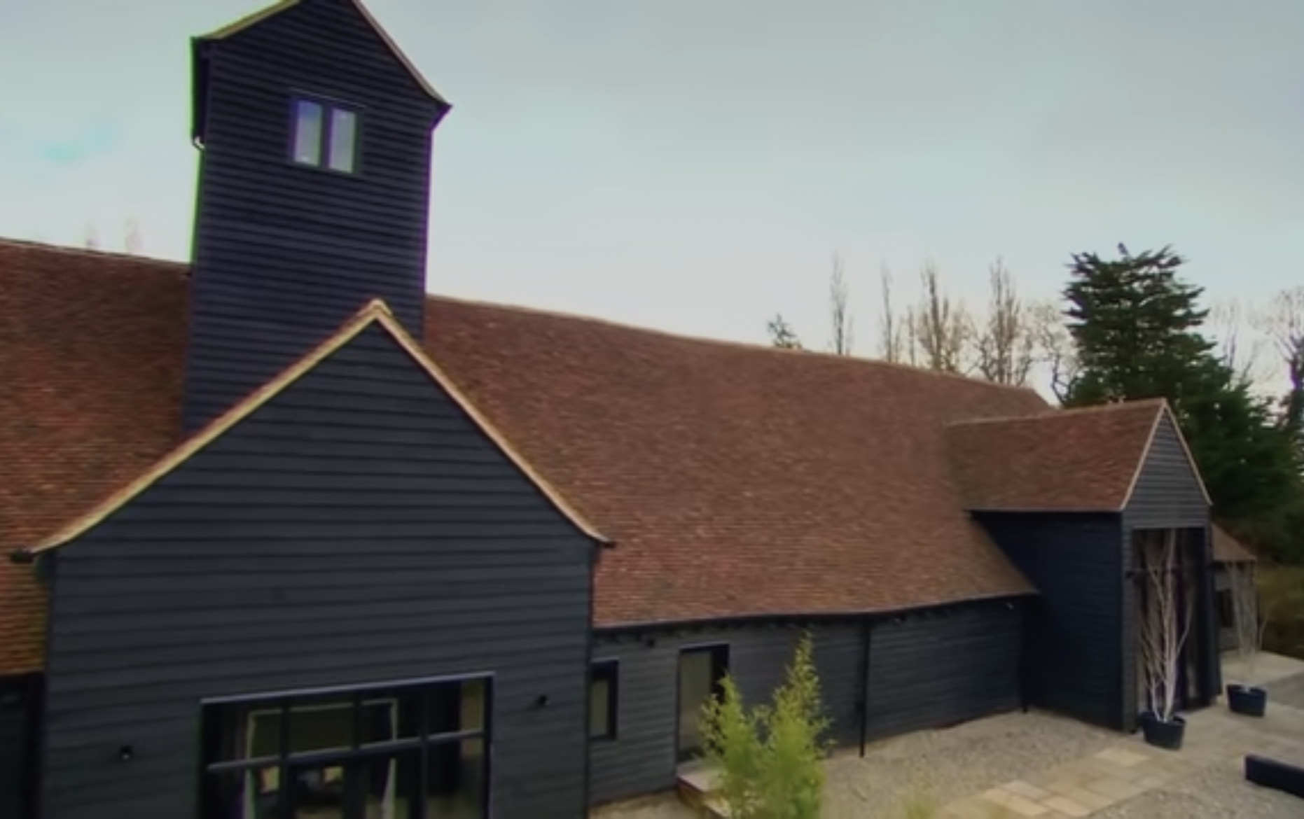 Aerial view of The Barn's restored exterior and gable tower