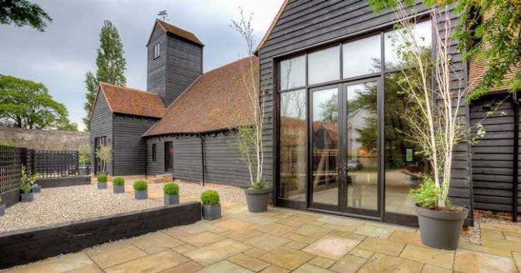 Restored exterior of The Barn with black timber cladding