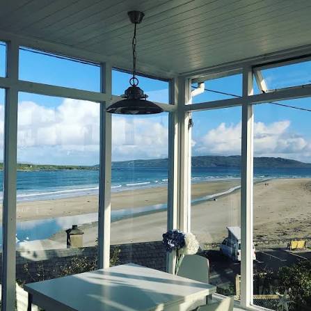 Dining table with a direct beach view at Carnaween House
